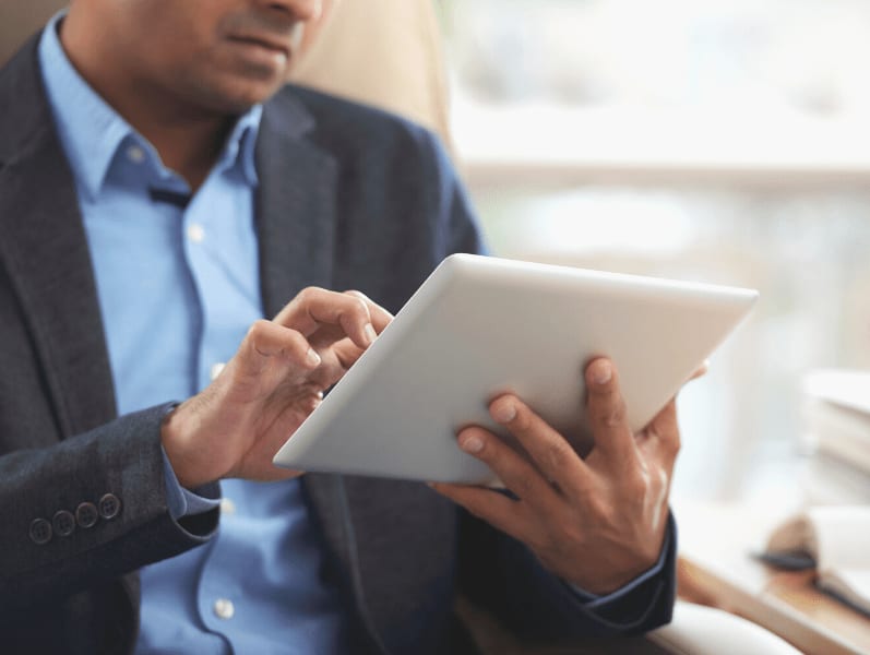 Man on using tablet technology to work on a project