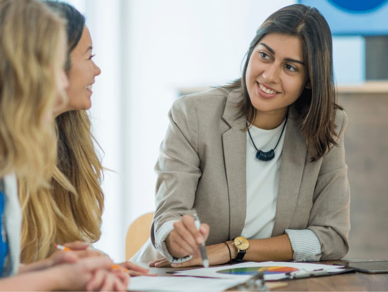 Woman employee talking to her coworkers.