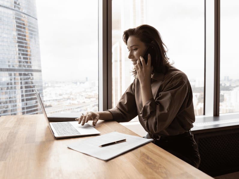 Young busy businesswoman multitasking in modern office.