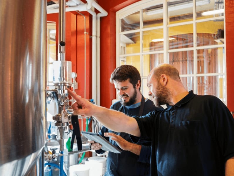 Two people in a micro brewery in Denmark.