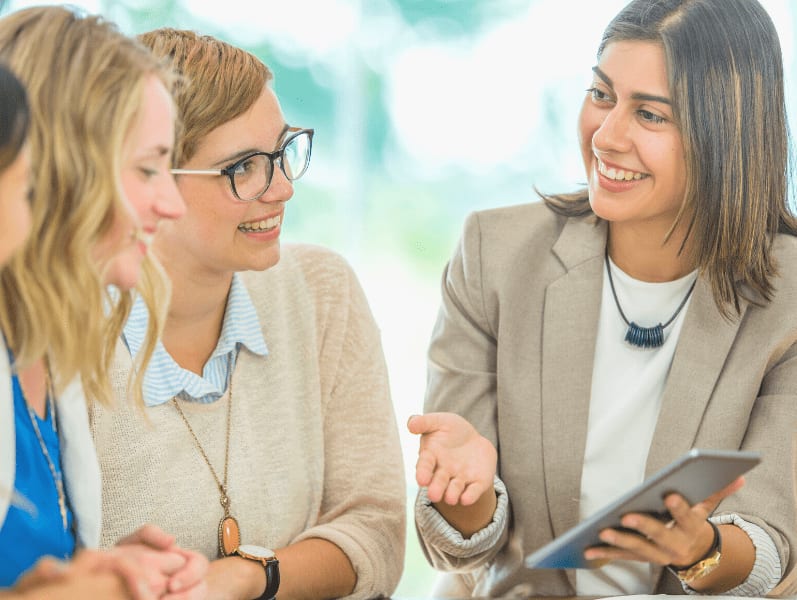 Female leader sharing with team on new technology